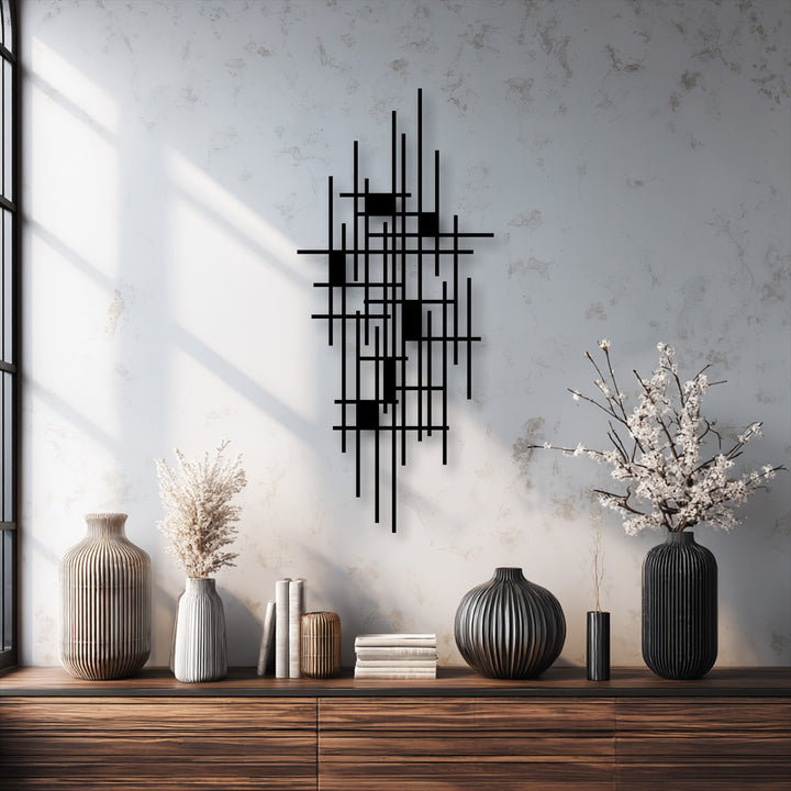 The background reveals a textured off-white wall with soft window light, elegantly accentuating the decorative metal art.