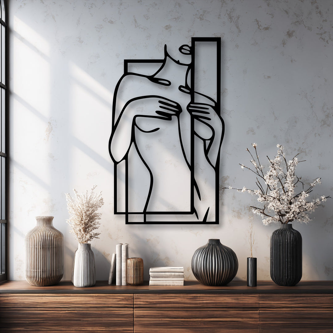 The striking black edges and bold geometric frame of the unique metal wall art delineate a minimalist female figure.