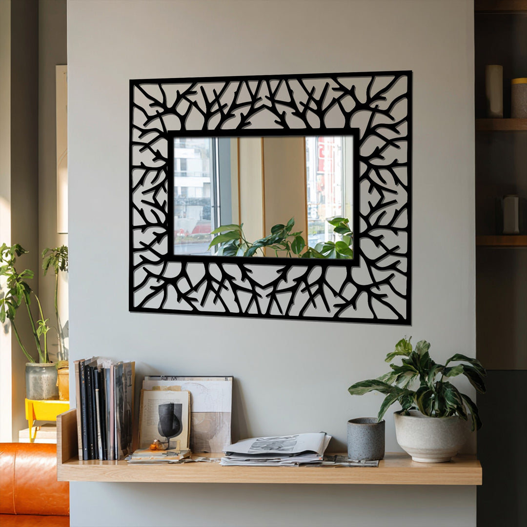 Branching out, the abstract metal artwork mirror frame gives the illusion of leaves in the wind, adding kinetic energy to your modern wall mirrors.