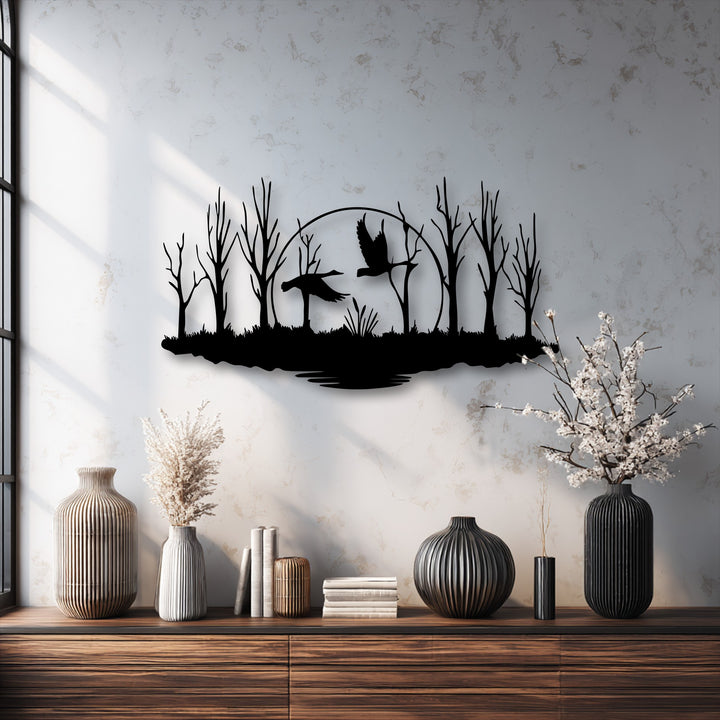 The distressed pale off-white wall serves as a subtle background for the striking flying birds forest metal wall decor.