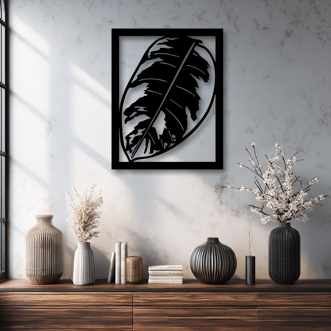 Visual rhythm emanates from the bold metal leaf decoration wall art, harmonizing with ribbed vases and striking window light patterns.