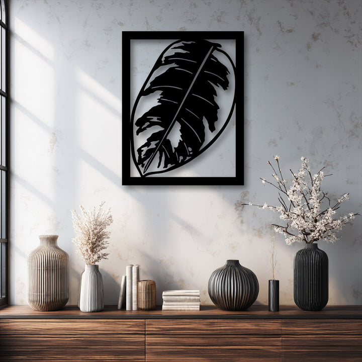 Visual rhythm emanates from the bold metal leaf decoration wall art, harmonizing with ribbed vases and striking window light patterns.