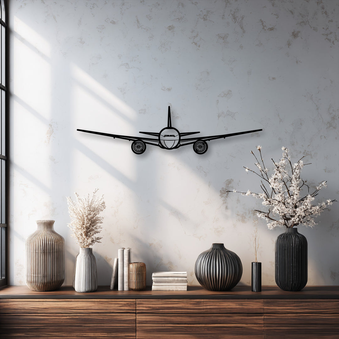 The black front view airplane silhouette is the clear focal point, offering captivating aviation metal wall decor against a textured wall.