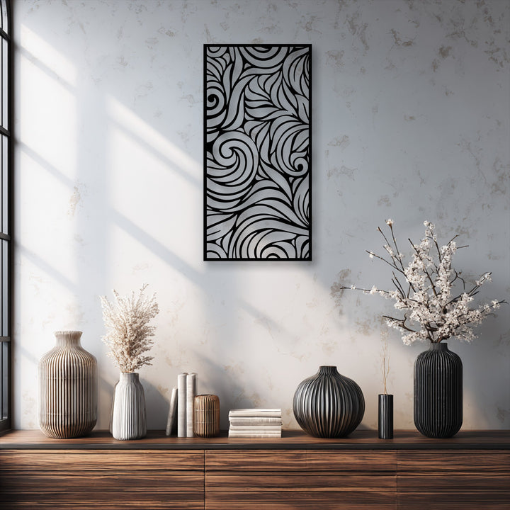 The interplay of natural light and intricate shadows highlights the swirling patterns of the metal artwork hanging above a rustic wooden console.