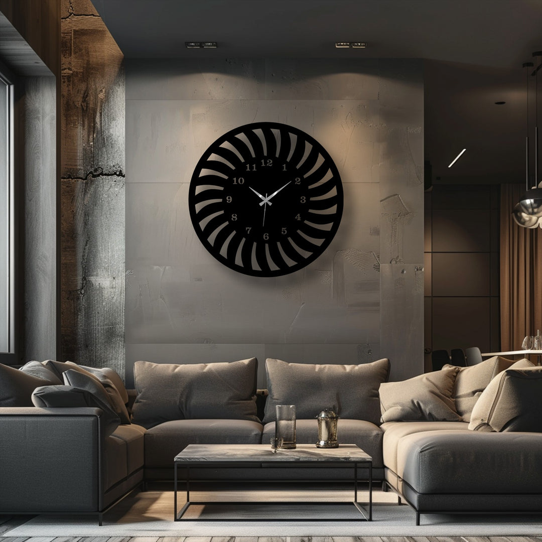 A circular black metal clock with a unique radial spiral pattern forms a piece of unique metal wall art.