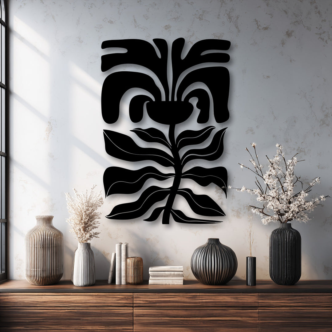 The negative space vividly outlines the abstract floral face metal art for wall, creating a modern botanical line decor against the textured white wall.