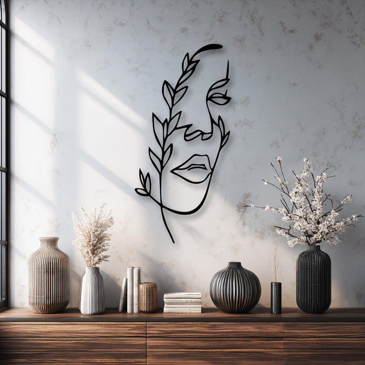 Organic forms of a minimalist female line art metal wall art with botanical branches, creating a stunning piece of decorative metal art.