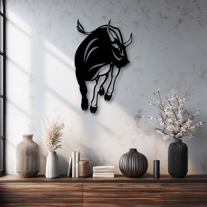 The darkest area highlights a powerful charging bull silhouette as metal art for wall, showcasing its strong form and dynamic movement.