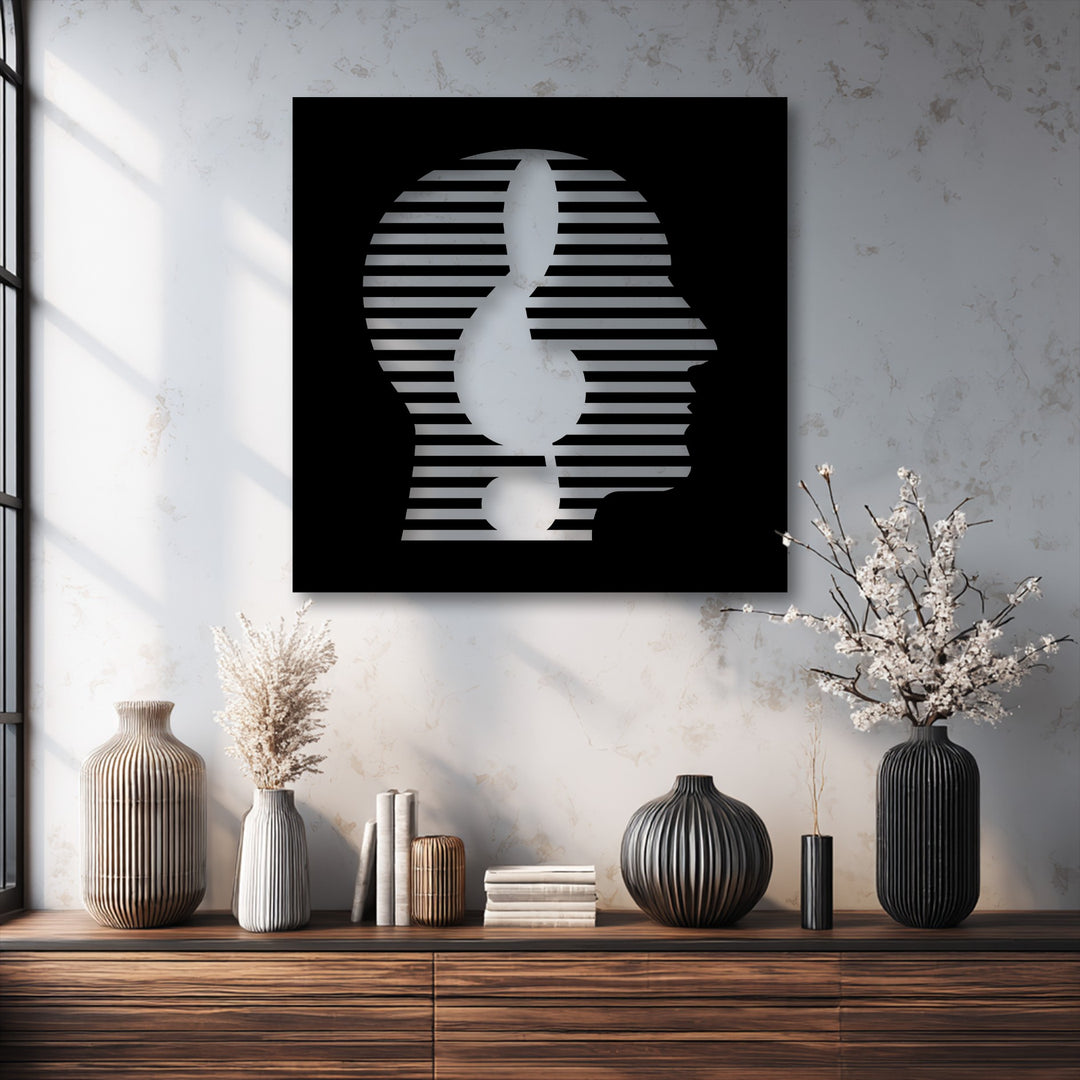 A striking black modern abstract face metal art for wall features a minimal striped line portrait and a white treble clef.