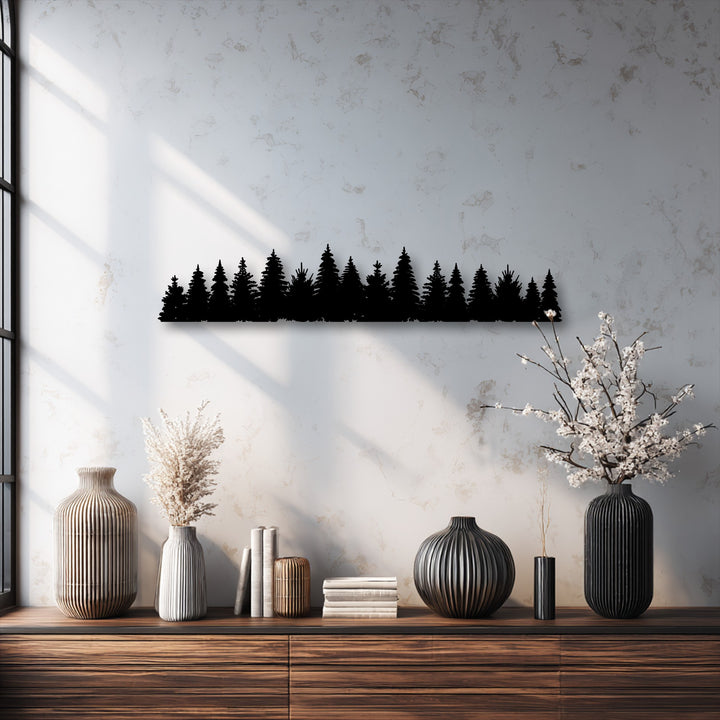 A prominent black pine forest silhouette, a minimalist metal art for wall, draws the eye against the textured wall above a wooden console.