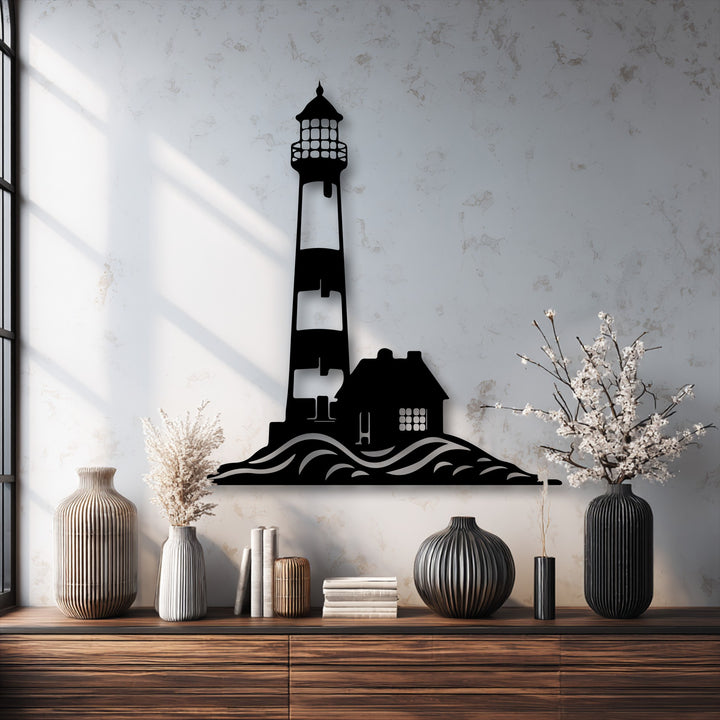 The distinct layers of the unique metal wall art show a coastal lighthouse silhouette, with subtle shadows adding depth to the ocean waves and house.