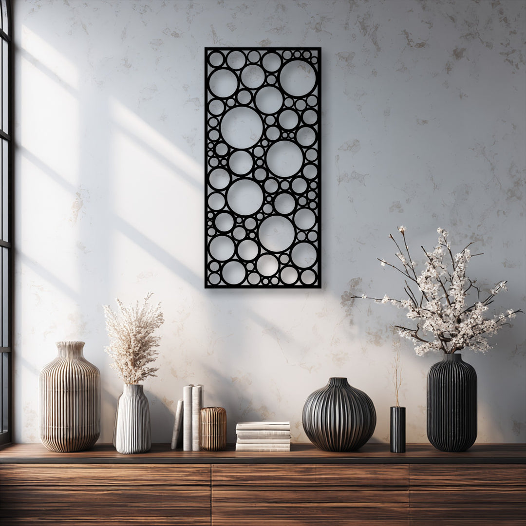 Elegant ribbed vases with dried flowers and books adorn a rich wooden console, enhancing the nearby modern abstract decorative metal art.
