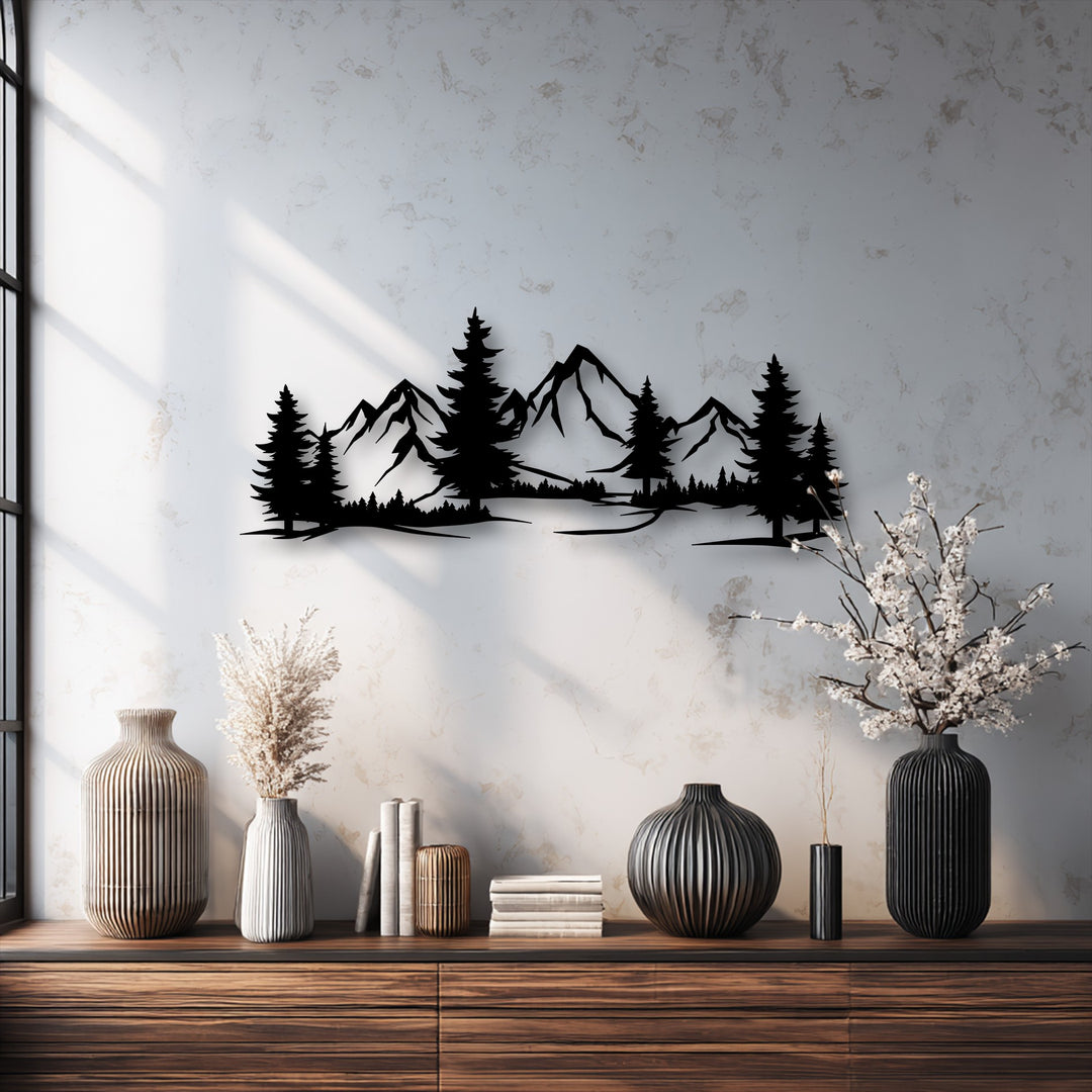 The striking silhouette of a unique metal wall art piece, showcasing majestic evergreen peaks and a dense mountain forest, is the focal point.