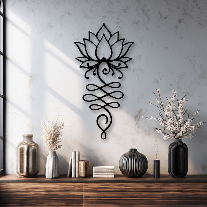 The focal point is an intricate black lotus flower unalome metal artwork, elegantly displayed on a textured white wall.