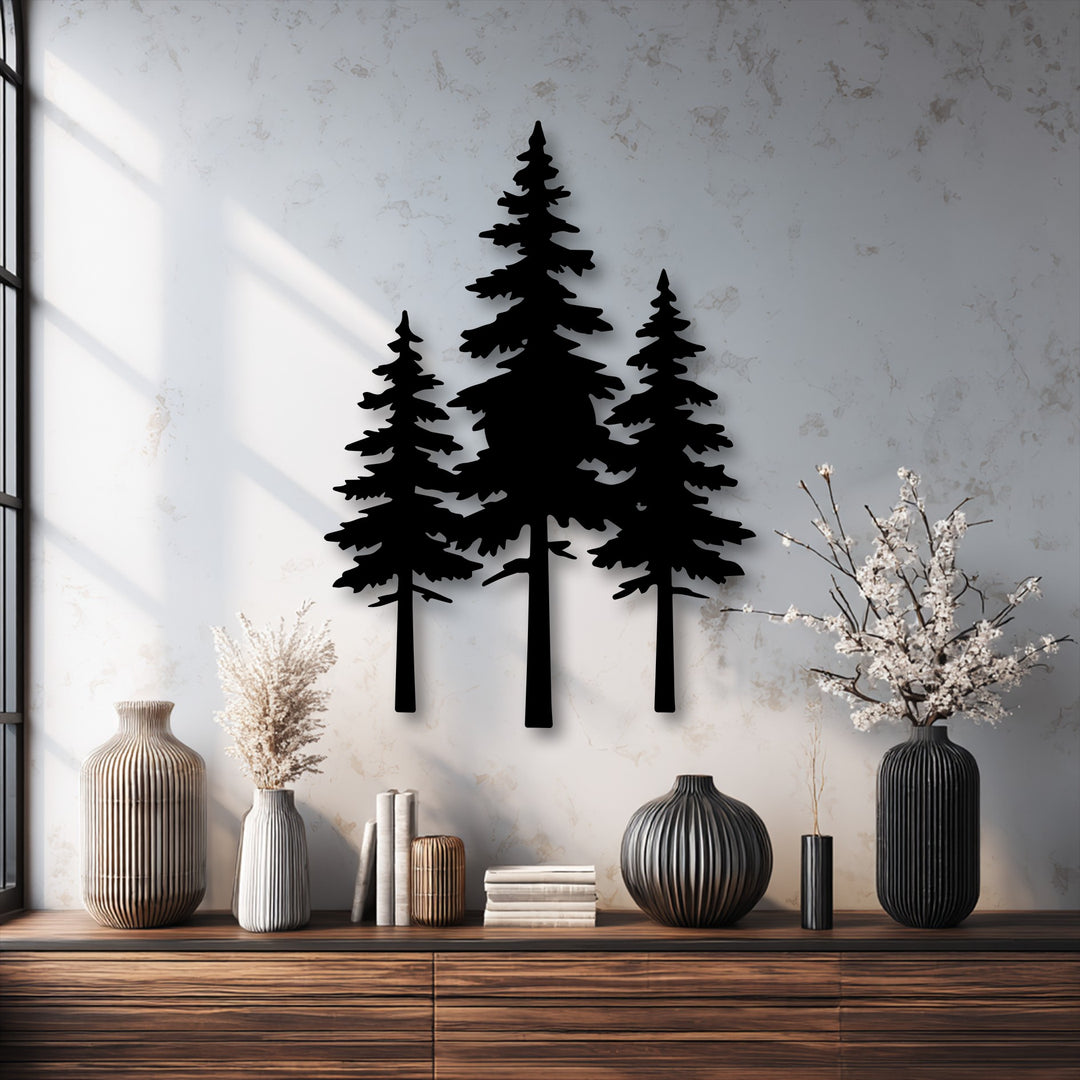 Negative space highlights the striking silhouettes of three pine trees crafted as decorative metal art, casting deep shadows on a bright textured wall.