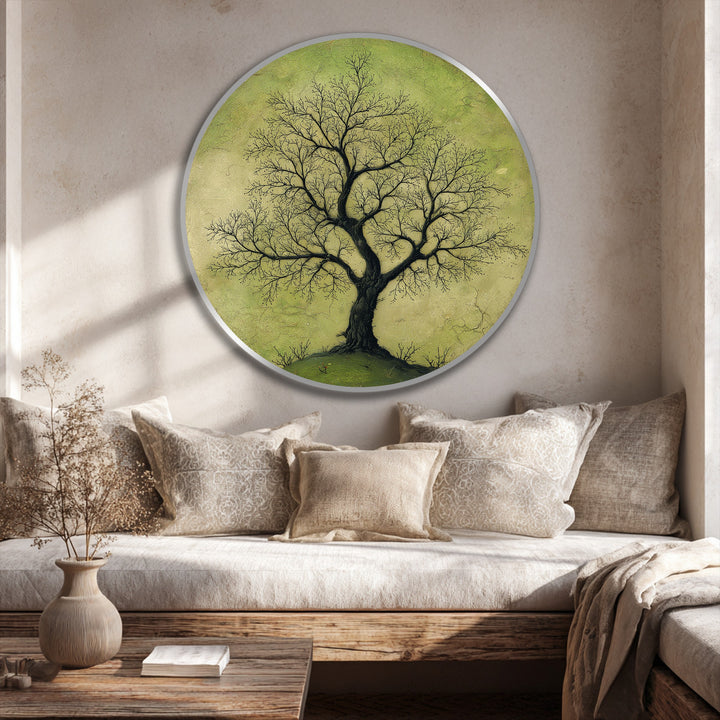 Soft, muted greens in this round oil painting artwork create a calming backdrop for the solitary, branching tree, offering nature-inspired wall art for serene interiors.