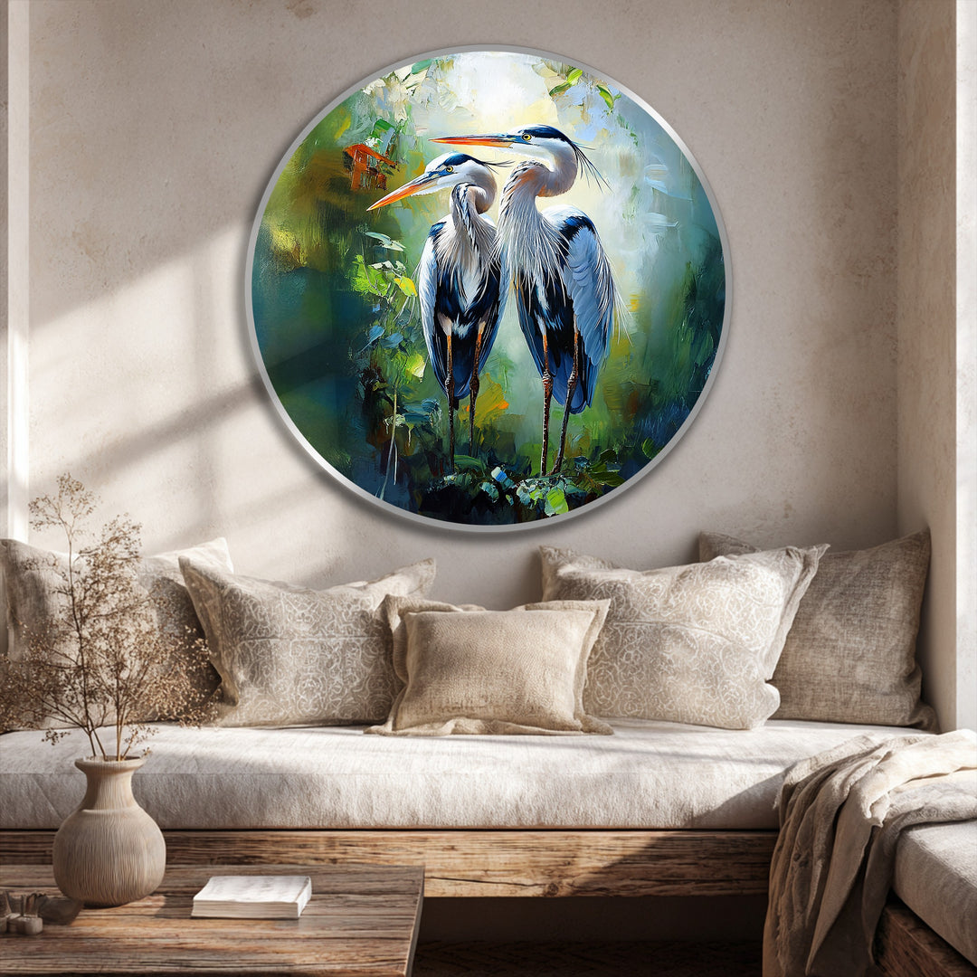 Subtle light and shadow interplay accentuate the elegant heron pair in this oil painting art piece, lending depth to the round canvas with its lush green tones.