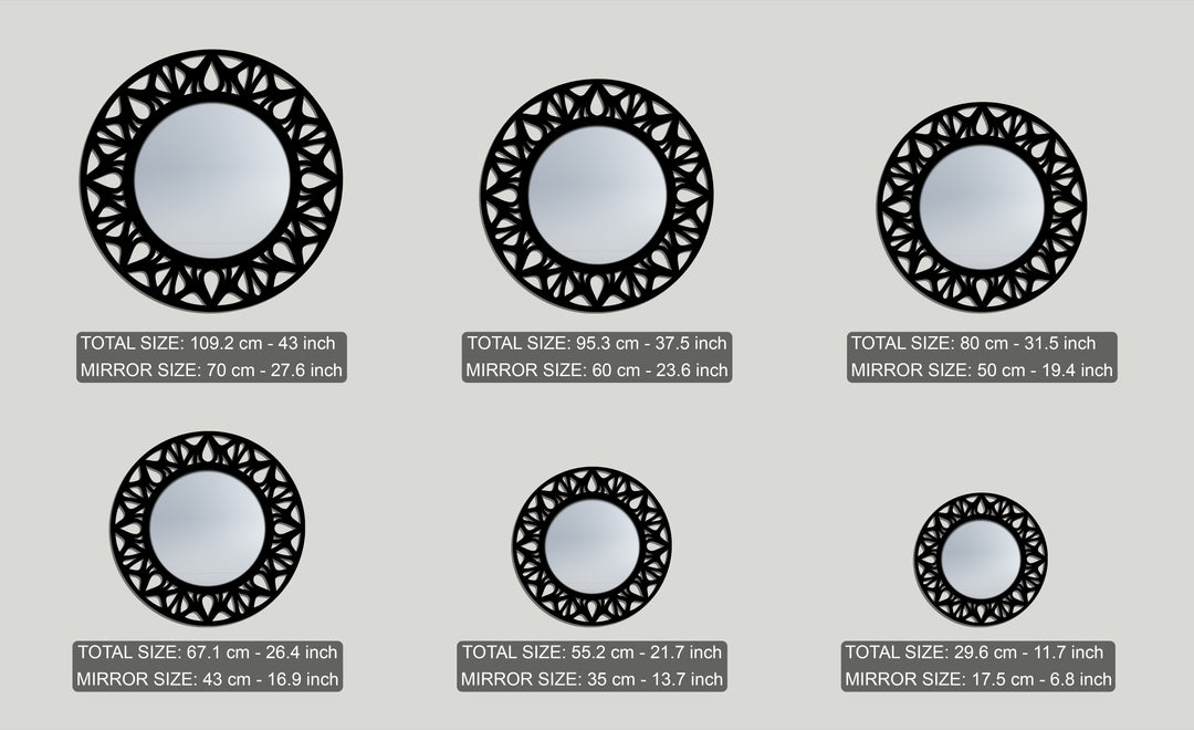 The elegant black floral cutout of each round framed wall mirror creates a distinct layered depth, presented in a collection of varying sizes.