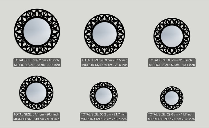 The elegant black floral cutout of each round framed wall mirror creates a distinct layered depth, presented in a collection of varying sizes.