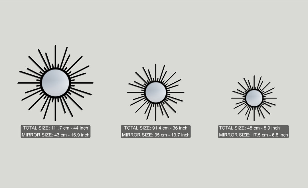 The soft light gray dominant color provides a backdrop for three striking black sunburst metal artwork mirrors of various sizes.