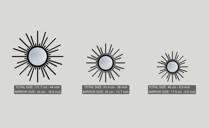 The soft light gray dominant color provides a backdrop for three striking black sunburst metal artwork mirrors of various sizes.