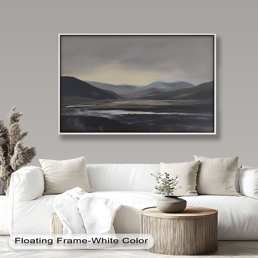 A dramatic mountain valley in shades of gray, with a wide nature panorama under a misty sky.

