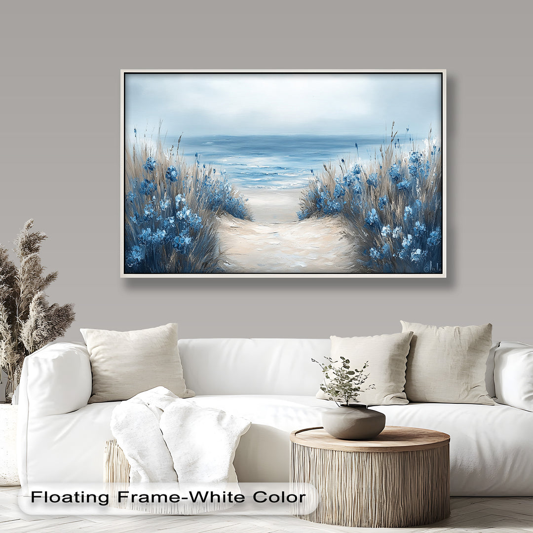 A soft coastal pathway lined with blue wildflowers leading to a calm, misty ocean under a pale sky.