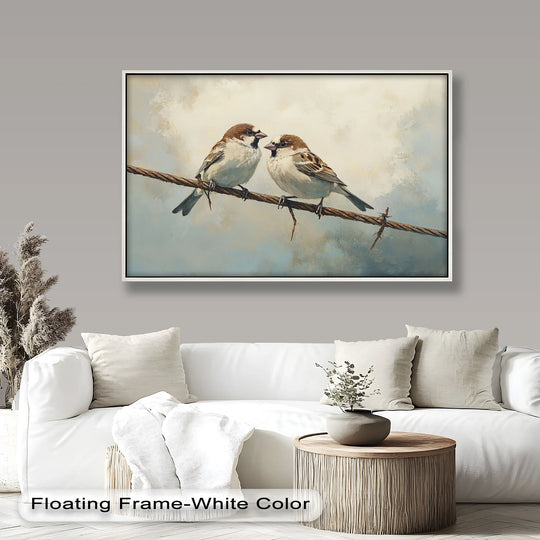 Softly painted clouds form the background for this oil painting artwork of two sparrows perched on a wire, presented in a white floating frame.