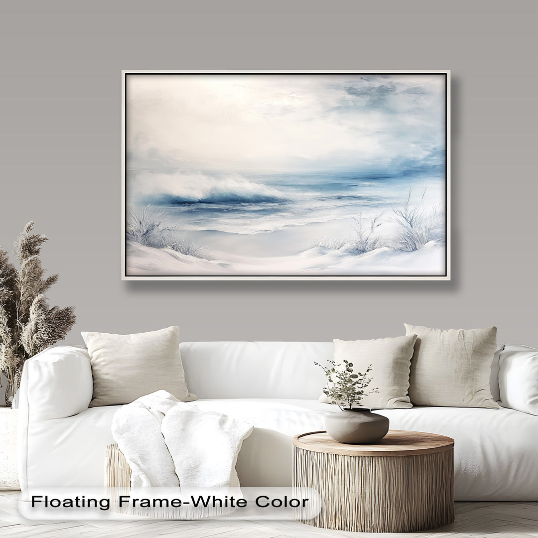 This ethereal winter seascape painting captures a quiet, snow-covered shoreline meeting soft ocean waves beneath a pale, misty sky.