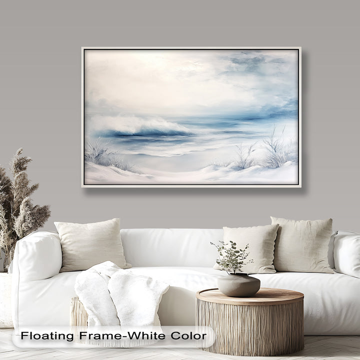 This ethereal winter seascape painting captures a quiet, snow-covered shoreline meeting soft ocean waves beneath a pale, misty sky.