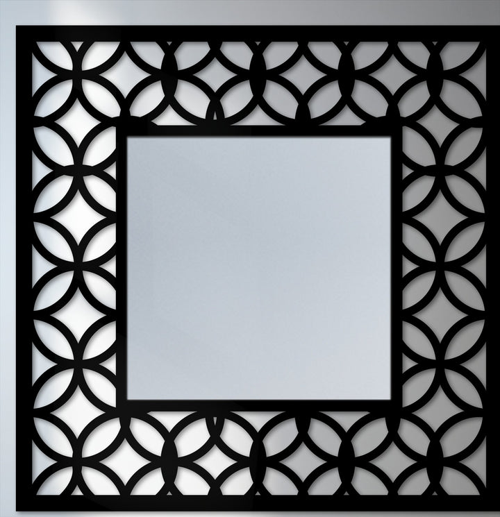 Illuminated with gleaming light, this modern mirror reflects the geometric frame, an interlocking circle pattern creating unique decorative metal art.