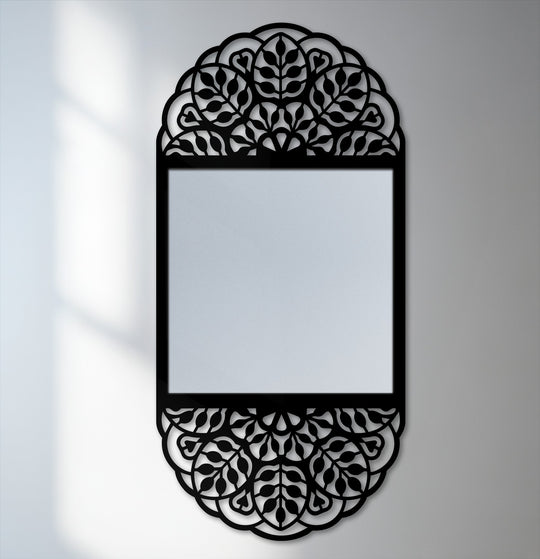 Vertical modern mirror with a rounded top and bottom and a rectangular mirrored center, framed with an ornamental floral mandala metal wall decor.