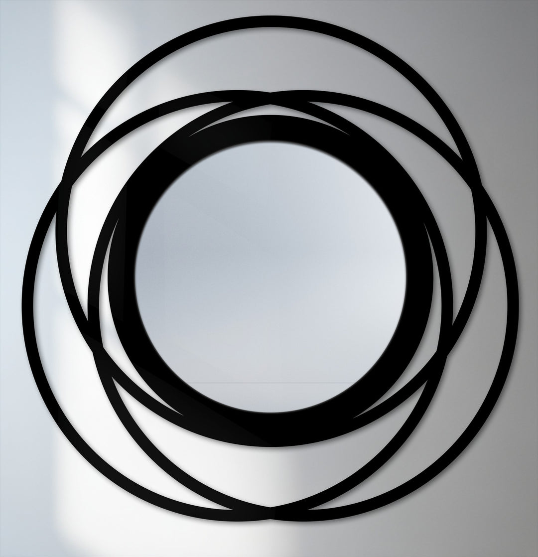 Intertwined rings of the framed wall mirror's black edge and borders create a captivating modern metal circle design.