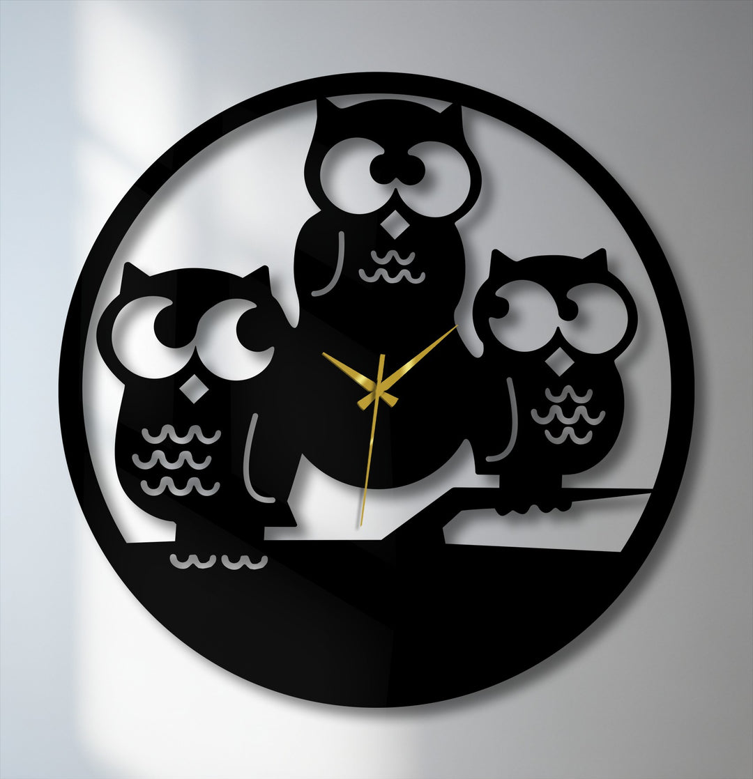 The brightest areas behind the three owls silhouette metal wall clock highlight their large, expressive eyes and contrast with the decorative metal art.