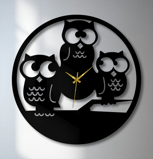 The brightest areas behind the three owls silhouette metal wall clock highlight their large, expressive eyes and contrast with the decorative metal art.