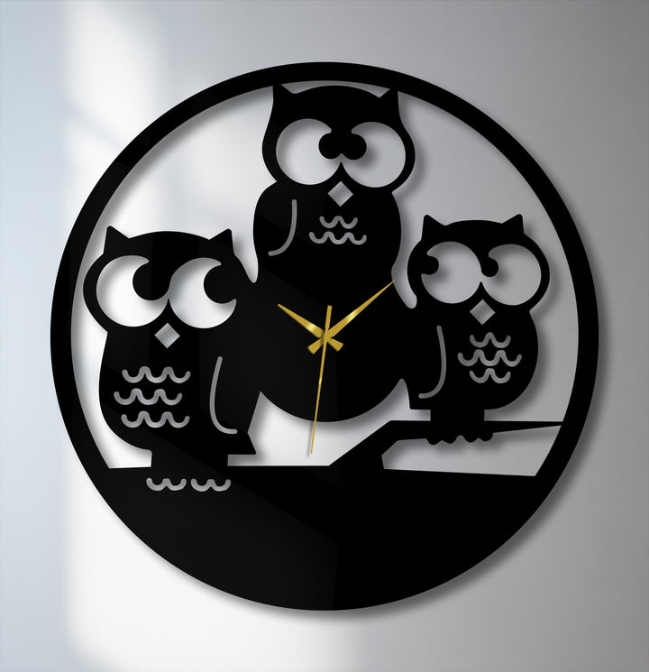 The brightest areas behind the three owls silhouette metal wall clock highlight their large, expressive eyes and contrast with the decorative metal art.
