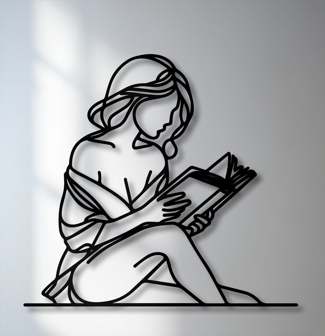 The soft, flowing silhouette of a quiet reader forms unique metal wall art, depicting a woman gracefully engrossed in a book.