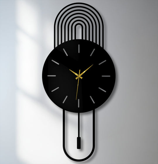 Abstract organic forms define this modern arc metal wall clock's pendulum and upper rainbow design, lending a touch of unique modern wall decor to the minimalist timepiece.