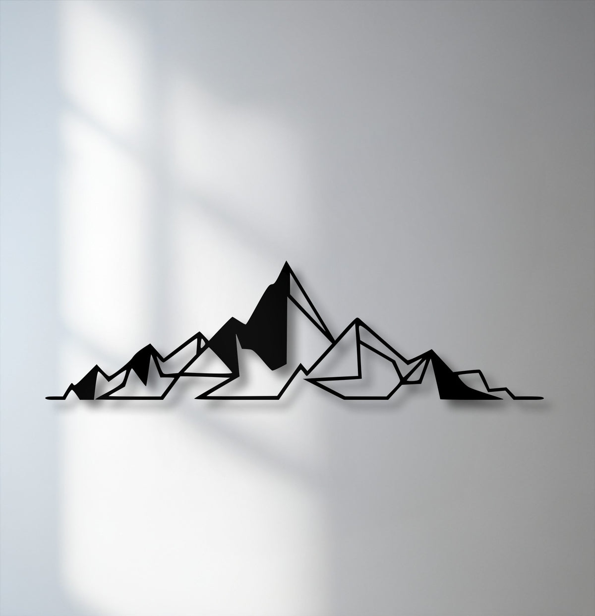 Against a light gray background, minimalist black metal art for wall depicts abstract geometric mountains with subtle shadows.