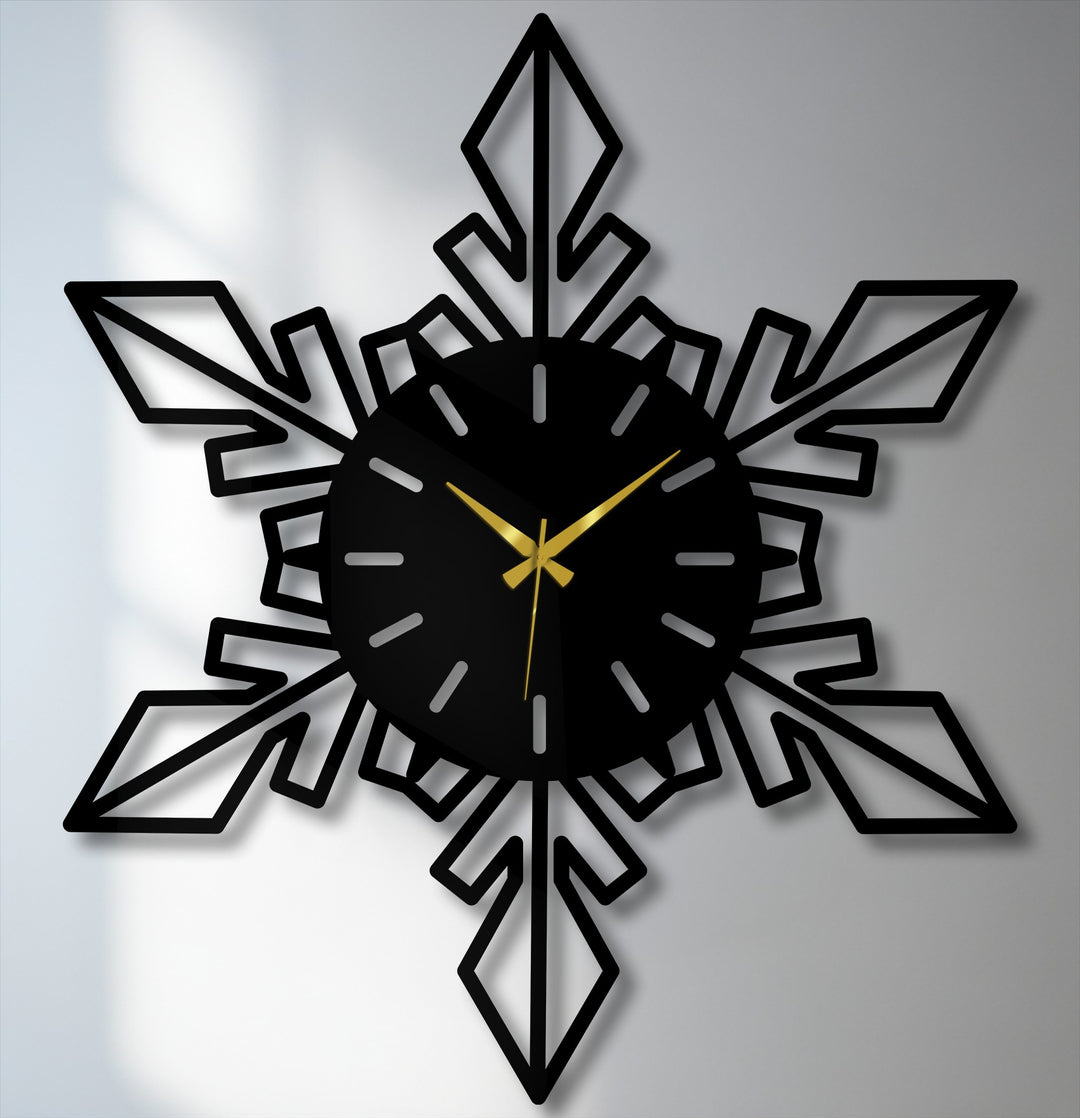 Subtle shadows provide a soft contrast to the geometric snowflake modern design of the unique metal wall art clock with elegant gold hands.