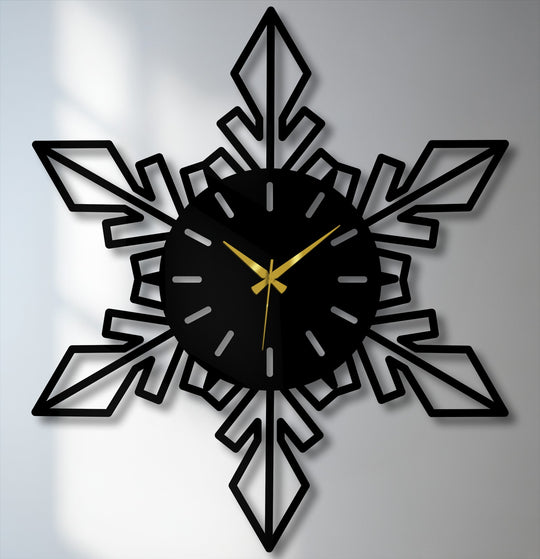 Subtle shadows provide a soft contrast to the geometric snowflake modern design of the unique metal wall art clock with elegant gold hands.