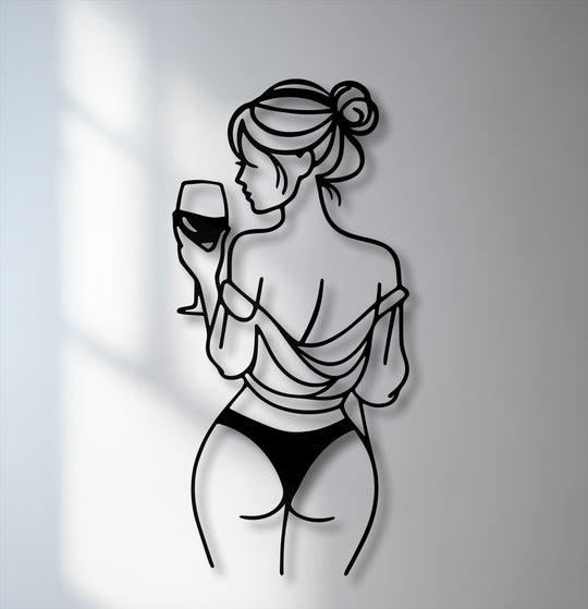 The soft interplay of light and shadow reveals a minimalist line art woman with a wine glass, forming unique metal wall art with striking depth.
