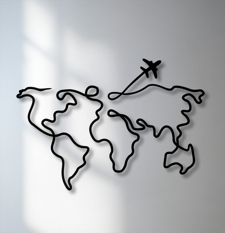 The focal point reveals a sleek black continuous line creating a minimalist world map and a silhouetted airplane, stunning decorative metal art.