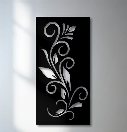 Organic forms of a swirling silver vine, detailed with graceful leaves and curls, create a unique metal wall art design on a sleek black background.