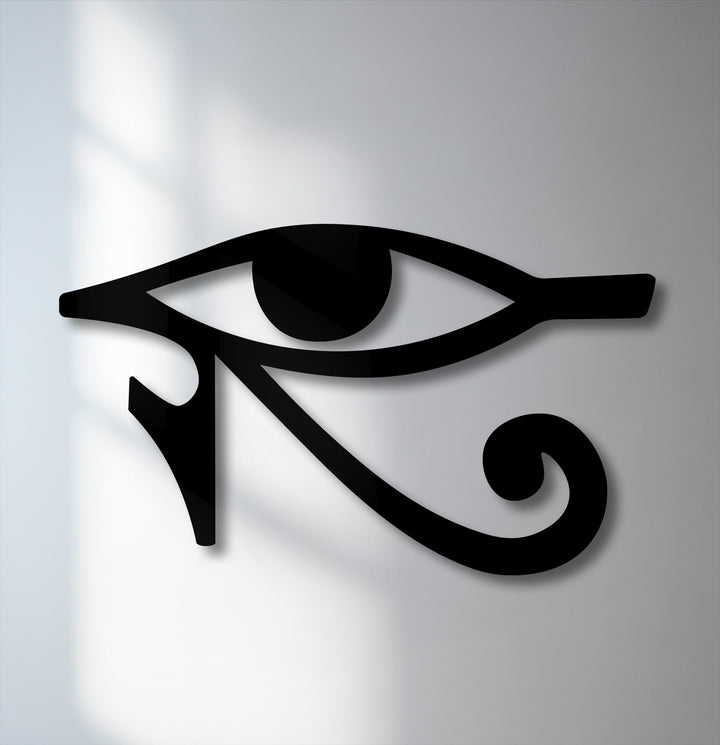 The geometric elements of the black Eye of Horus symbol form striking lines and curves in this ancient Egyptian metal wall decor.
