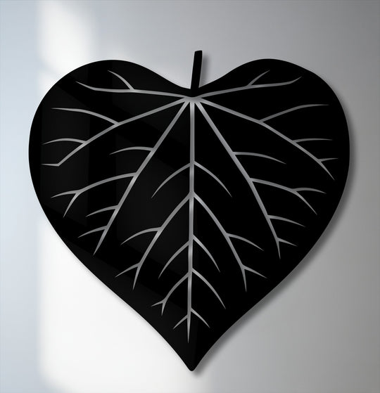 This unique metal wall art showcases an upright, heart-shaped leaf silhouette with intricate silver veins.