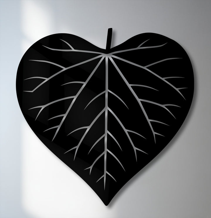 This unique metal wall art showcases an upright, heart-shaped leaf silhouette with intricate silver veins.