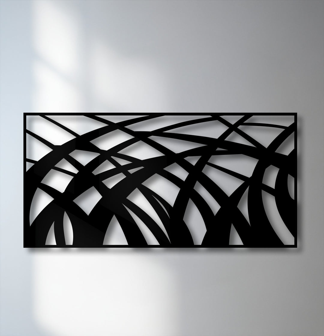 The brightest areas on the wall and through the abstract flowing lines of the decorative metal art emphasize its modern geometric wave panel design.
