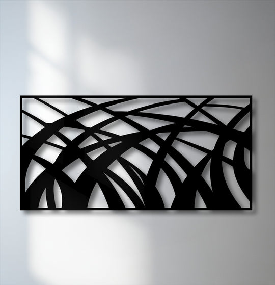 The brightest areas on the wall and through the abstract flowing lines of the decorative metal art emphasize its modern geometric wave panel design.