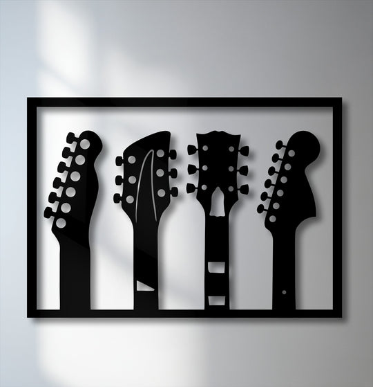 Striking black and white unique metal wall art featuring four guitar headstock silhouettes in a sleek black frame.